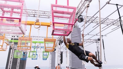 A wipeout obstacle at the Gov Games site on Kite Beach last year. Participants had to carry boxes, climb slopes and jump on planks suspended over water to win points for their teams. The National