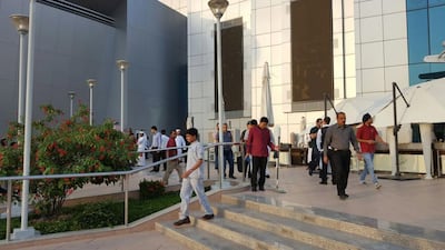 The mall was evacuated at about 6.15pm and about three fire trucks, four police patrol cars, one explosive ordinance disposal unit team, one K-9 unit and one ambulance were seen parked near the main entrance. Photo: The National staff