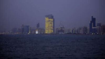 The Abu Dhabi Investment Authorities headquarters dominates the Corniche, burning brightly at night. Solar-powered blinds close during the day to keep the 1,000 employees cool.