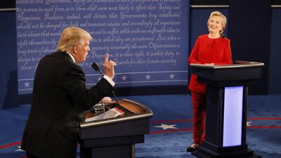 Democratic presidential nominee Hillary Clinton smiles as Republican presidential nominee Donald Trump speaks during the presidential debate at Hofstra University. Rick T. Wilking / AP Photo