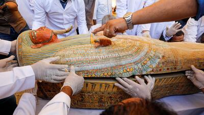 Archaeologists remove the cover of an ancient painted coffin discovered at Al Asasif Necropolis in the Vally of Kings in Luxor, Egypt. Reuters