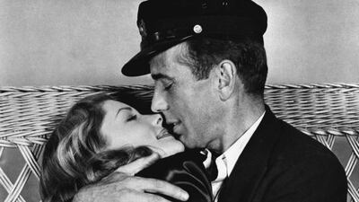 This 1944 file photo originally released by Warner Bros. shows actor Humphrey Bogart, right, holding actress Lauren Bacall in a scene from, To Have and Have Not. AP, Warner Bros. Pictures, File
