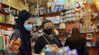 Residents living in Saudi Arabia inspect Christmas decorations at a shop in the Swailem market in Riyadh. AFP