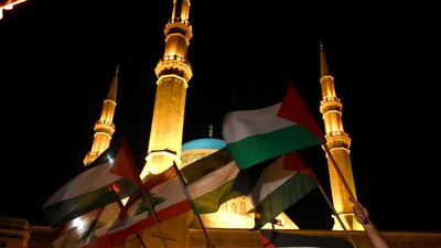 Protesters carry Palestinian and Lebanese flags during a protest to show solidarity with the Palestinians in Jerusalem and the West Bank in downtown Beirut, Lebanon. EPA