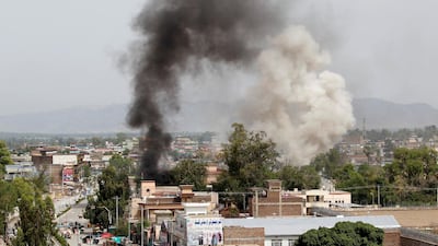 Smoke rises from the site of a blast and gunbattle between Afghan security forces and a handful of militants in Jalalabad, Afghanistan, on May 13, 2018. Parwiz / Reuters