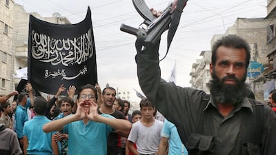 Supporters of Al Nusra take part in a protest against Syrian President Bashar Al Assad and the international coalition in Aleppo on September 26. Fadi Al Halabi / AFP Photo