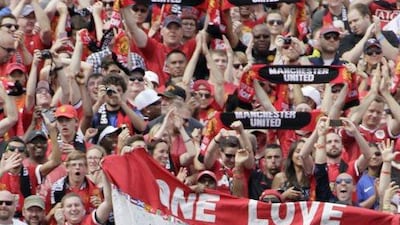 Manchester United fans cheer for the club after Ashley Young, second left, scores on Saturday against Real Madrid at the International Champions Cup. To his left, Phil Jones and to his right, Michael Keane, No 38 and Wayne Rooney, No 10, celebrate with him. Duane Burleson / Getty Images / AFP