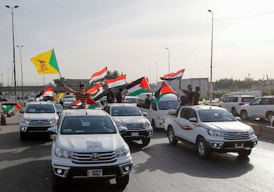 Members of Kataib Hezbollah, the Iran-backed militia in Iraq, take part in a parade in Baghdad to mark Quds Day on May 6, 2021. Reuters