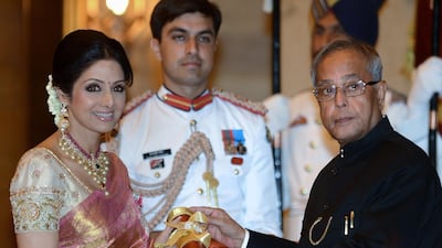 This photo taken on April 5, 2013 shows then-Indian President Pranab Mukherjee (R) presenting the Padma Shree award to Indian film actress Sridevi (L) during the presentation of the "Padma Awards 2013" at the Presidential Palace in New Delhi. AFP