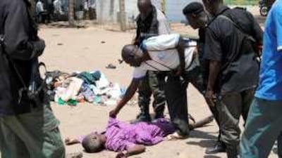Nigerian police check the body of an alleged rebel killed in a shootout yesterday in Maiduguri.