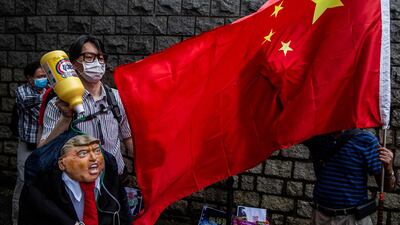 A pro-China activist holds an effigy of US President Donald Trump during a protest outside the US consulate in Hong Kong. AFP