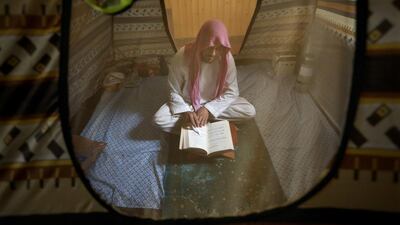 An Afghan Muslim man reads versus of the Quran in a mosque during Itikaf, the last ten days of the Islamic fasting month of Ramadan, in Kabul, Afghanistan. Rahmat Gul / AP Photo