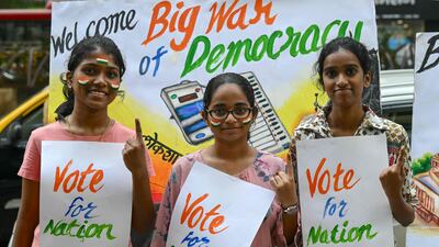 Art school students pose with posters illustrating the upcoming India's parliamentary elections, in Mumbai on Saturday. AFP
