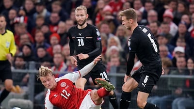 Denmark's Kasper Dolberg, left, and Austria's Martin Hinteregger, right, battle for the ball. AP