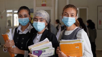 Girls pose for a picture before going to class on the first day of school in a Yazidi displaced persons camp in the Sharya area, about 15 kilometres from the city of Dohuk in Iraqi Kurdistan. AFP