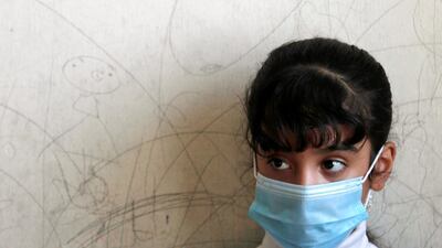 A student wears a protective face mask at a school in Baghdad, Iraq. Reuters