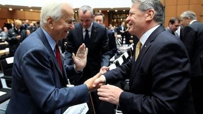 Richard von Weizsaecker, the former mayor of West Berlin, left, greets a former East German opposition activist, Joachim Gauck, yesterday at a unification commemoration in Berlin. Thomas Peter / Reuters