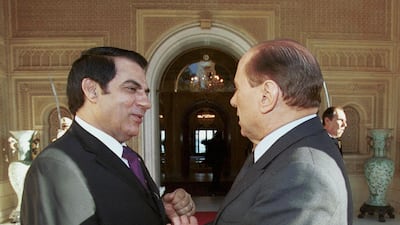Former Tunisian president Zine El Abidine Ben Ali greets Mr Berlusconi at the presidential palace in Tunis in November 2001. AFP
