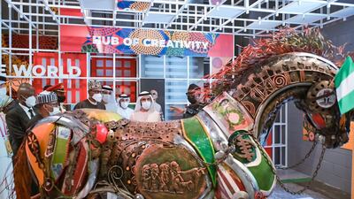 Sheikh Mohammed explores the colourful Nigerian pavilion.