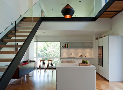 Contemporary kitchen, Habitat 67, Montreal, designed by Moshe Safdie showing Beat Fat Pendant by Tom Dixon. Getty Images