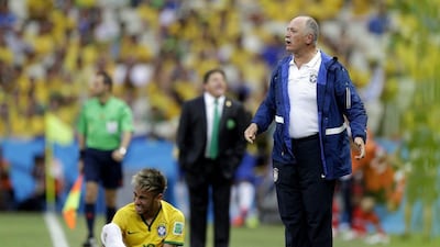 Luiz Felipe Scolari stands on the touchline with Neymar during Brazil's draw with Mexico on Tuesday night at the 2014 World Cup. Andre Penner / AP / June 17, 2014