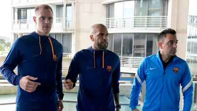 Xavi Hernandez, Marc-Andre ter Stegen, and Dani Alves pose for a photo after a press conference in Sydney. AP