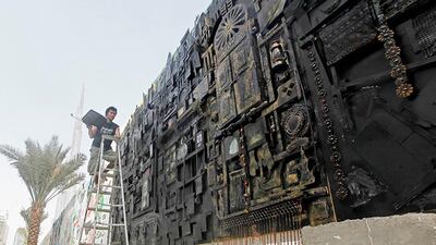 Dubai, United Arab Emirates - May10, 2012. Darwin "Japat" Guevarra a highly regarded Filipino artist, is on his first daring mixed media artwork that measures 9 meters by 3 meters. Japat's ( as his friends fondly call him ) masterpiece were divide into seven parts, then will be connected or combined when displayed. His masterpiece were truly exceptional since he painstakingly draw, cut out, rivited and painted each component to form his inspiration and love for Dubai. The artwork will be featured in the Outdoor Art Project 2012, behind the Executive Towers of Business Bay. ( Jeffrey E Biteng / The National )