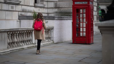A woman carries two pot plants towards Westminster underground station in London, England. As the COVID-19 coronavirus pandemic continues to escalate, London's streets have grown quieter as more people are encouraged to work from home and respect "social distancing" in a bid to slow the spread of the virus. Getty Images