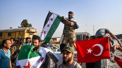 Turkish-backed Syrian opposition fighters celebrate in Akcakale, in Sanliurfa province advance, after entering over the border from Tal Abyad, Syria. AP Photo