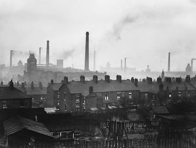 Cotton mill chimneys belching smoke in Manchester in 1936. Fox Photos / Getty Images