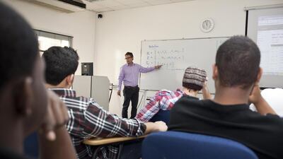 Dr John Taylor, one of the faculty members recruited from the United States of America, teaches a class at the American University of Ras Al Khaimah. Antonie Robertson / The National