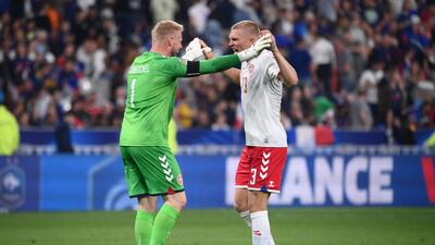 Denmark's goalkeeper Kasper Schmeichel celebrates the win with Rasmus Kristensen. AFP