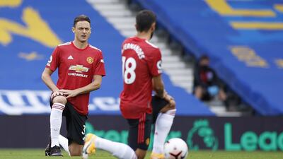 Nemanja Matic, left, and Bruno Fernandes of Manchester United take a knee before the start of the match. EPA