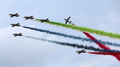 The Al Fursan flying team take to the skies during the air show on the Corniche in Abu Dhabi. Pawan Singh / The National