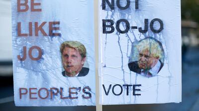 A placard in favour of a second referendum features former UK foreign secretary Boris Johnson his brother Jo Johnson. Reuters