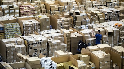 Workers prepare customer orders for dispatch as they work around goods stored inside an Amazon.co.uk fulfillment centre in Peterborough. AFP