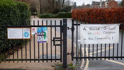 Signs are seen on the gates of Moulsecoomb Primary School in Brighton as it remains shut on what should have been the first day of school after Christmas break. Reuters