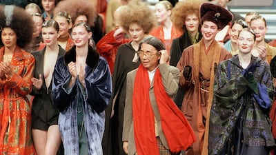 Japanese fashion designer Kenzo, centre, salutes the audience at the end of his ready-to-wear fall / Winter 1998/99 collection presentation in Paris on March 13, 1998. AFP
