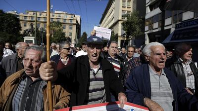 Greek pensioners, during a rally in Athens last week, are suffering from the downside of a single currency during a financial crisis, that it cannot devalue and the government remains in debt. Thanassis Stavrakis / AP Photo