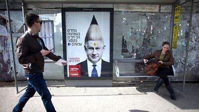 A commercial poster for an Israeli school with the manipulated image Israeli prime minister Benjamin Netanyahu hangs on a bus stop ahead of the upcoming Israeli elections. Uriel Sinai / Getty Images