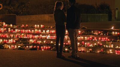 Students stand in front of candles in front of the Joseph-Koenig Gymnasium in Haltern, western Germany. A stunned German town mourned 16 students who went down aboard Germanwings flight on their way home Tuesday from a Spanish exchange programme. Martin Meissner / AP Photo