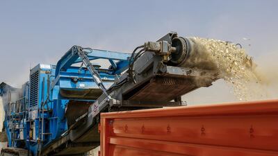A crushing machine pullverizes and destroys more than 8 tons of illegal ivory at the Al Qusais landfill. Victor Besa for The National.
