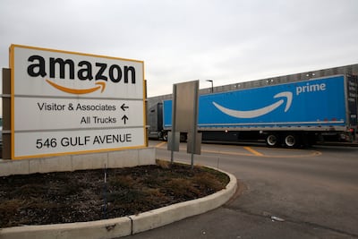 An Amazon Prime truck passes by a sign outside an Amazon fulfillment center in Staten Island, New York. AP