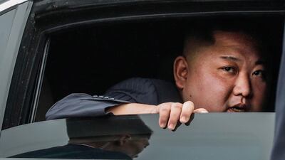 Kim Jong-un looks out from a vehicle as he arrives in Dong Dang. EPA
