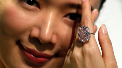 A model poses with a 37.30-carat 'The Raj Pink', the world's largest known fancy intense pink diamond expected to fetch up to $30 million in an upcoming Geneva auction, during a Sotheby's preview in Hong Kong. Bobby Yip / Reuters