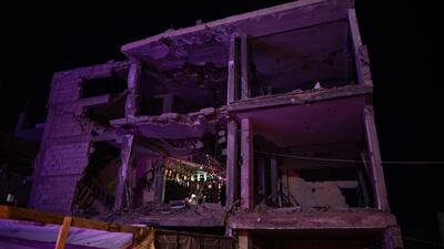 A Palestinian family prepare for Ramadan inside their ruined home in Khan Younis, in southern Gaza. EPA