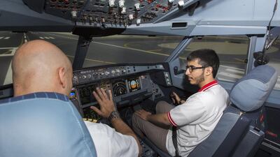 A student tries his hand at the cockpit controls during a simulated flight to Abu Dhabi International Airport, guided by an Etihad Airways captain. Courtesy Etihad