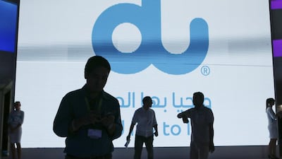 People walk by a digital screen at the du stand at the 25th Gitex Technology Week at Dubai World Trade Centre in Dubai, on October 19, 2015. Sarah Dea / The National