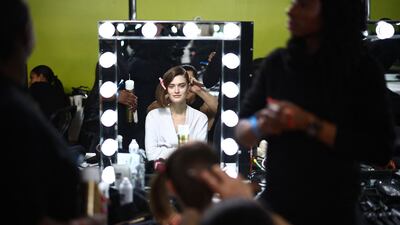 A model is prepared backstage before the catwalk presentation for British label JW Anders during London Fashion Week. AFP