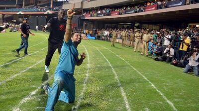 Indian cricketer Yuvraj Singh mimics Usain Bolt's race celebrate after they run a friendly 100-metre sprint on Tuesday following their exhibition cricket match. Manjunath Kiran / AFP